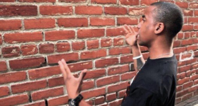 A person trying to talk to a brick wall